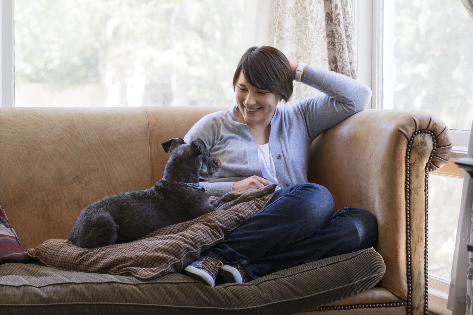 Woman and dog in sofa